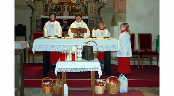 A woman dressed as a priest appearing to say mass